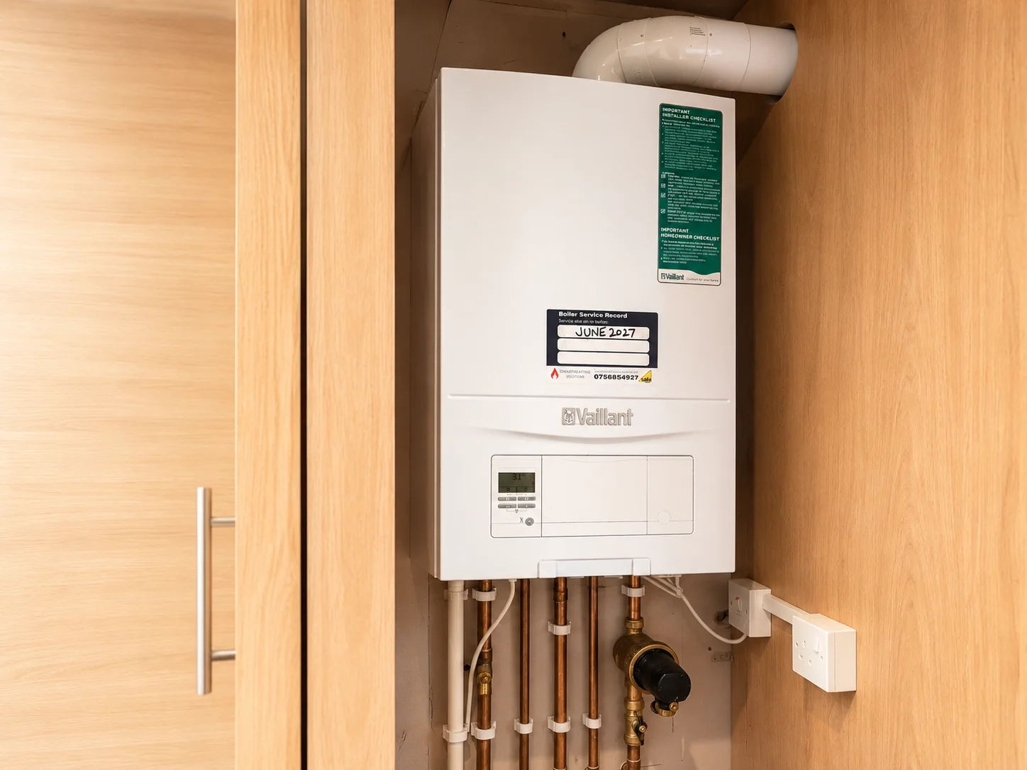 Neatly installed premium combi boiler with tidy copper pipework